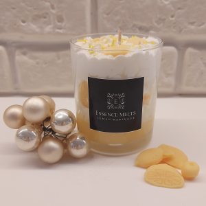 Lemon Meringue - candle in a glass jar with whipped white topping, yellow sprinkles, and lemon-shaped wax accents, displayed with pearl ornaments. Dessert candles