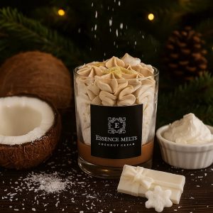 Coconut Cream candle in a glass jar with whipped wax topping, surrounded by pearl baubles and white wax embellishments on a white background. Dessert candles