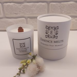 Cotton Flower - Candle in elegant white glass jar on neutral background. Spa Candles