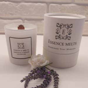 White Musk & Lavender scented candle burning in a white glass container with a crackling cherry wood wick. Spa Candles
