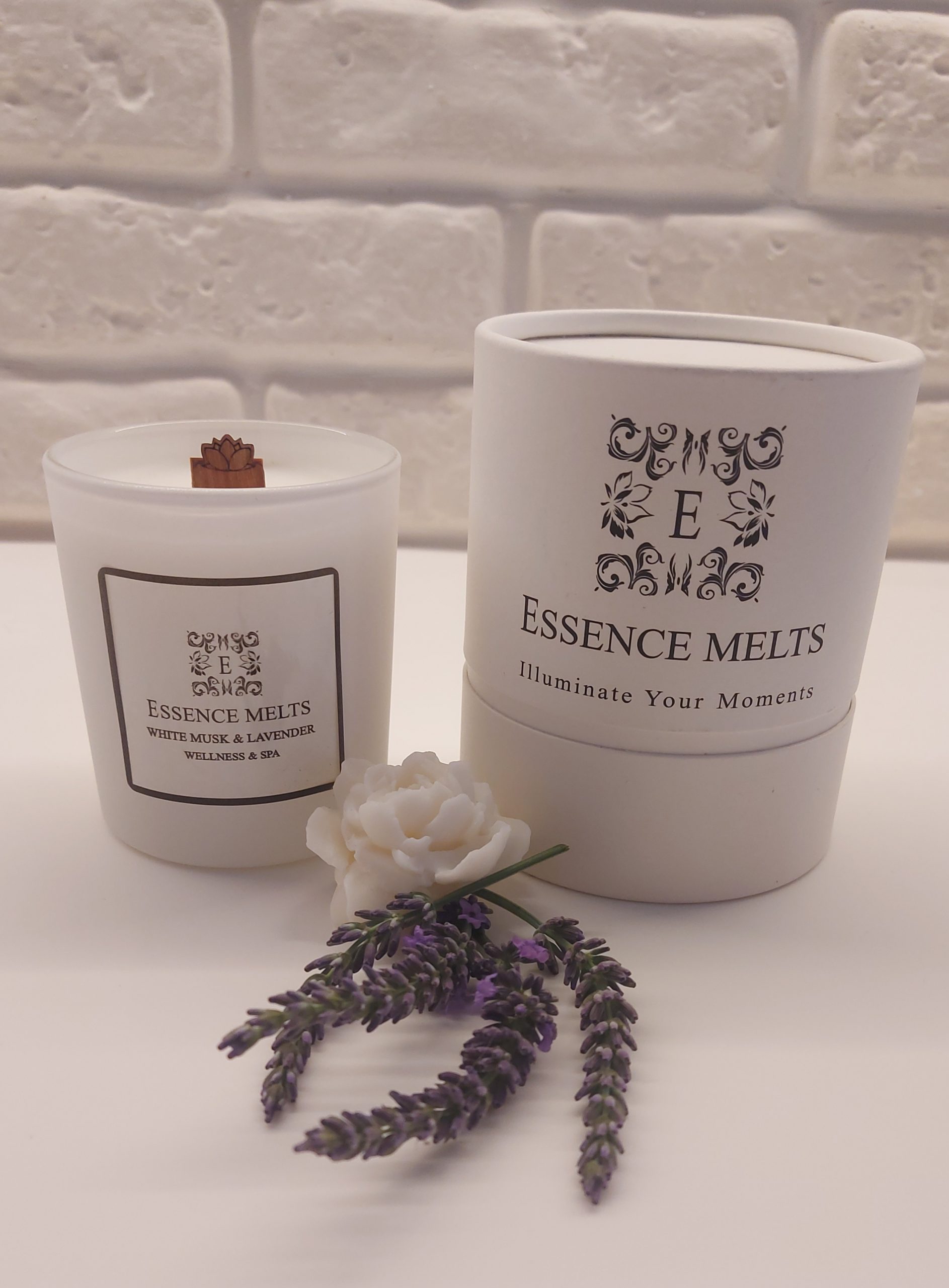 White Musk & Lavender scented candle burning in a white glass container with a crackling cherry wood wick. Spa Candles