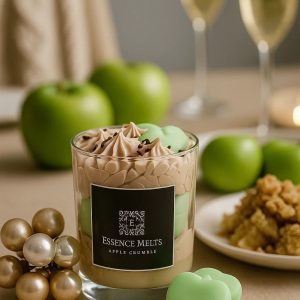 Apple Crumble candle in a glass jar with whipped topping, chocolate sprinkles, and green apple-shaped wax, styled with pearl decorations. Dessert candles