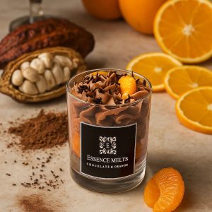 Orange Chocolate - candle in a glass jar with whipped chocolate topping, chocolate sprinkles, and realistic orange segment wax accents, displayed with pearl ornaments. Dessert candles