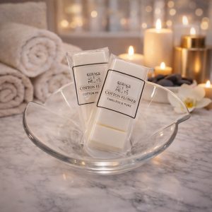 Essence Melts Cotton Flower handmade soy wax melt bars in elegant spa setting with candles and marble background