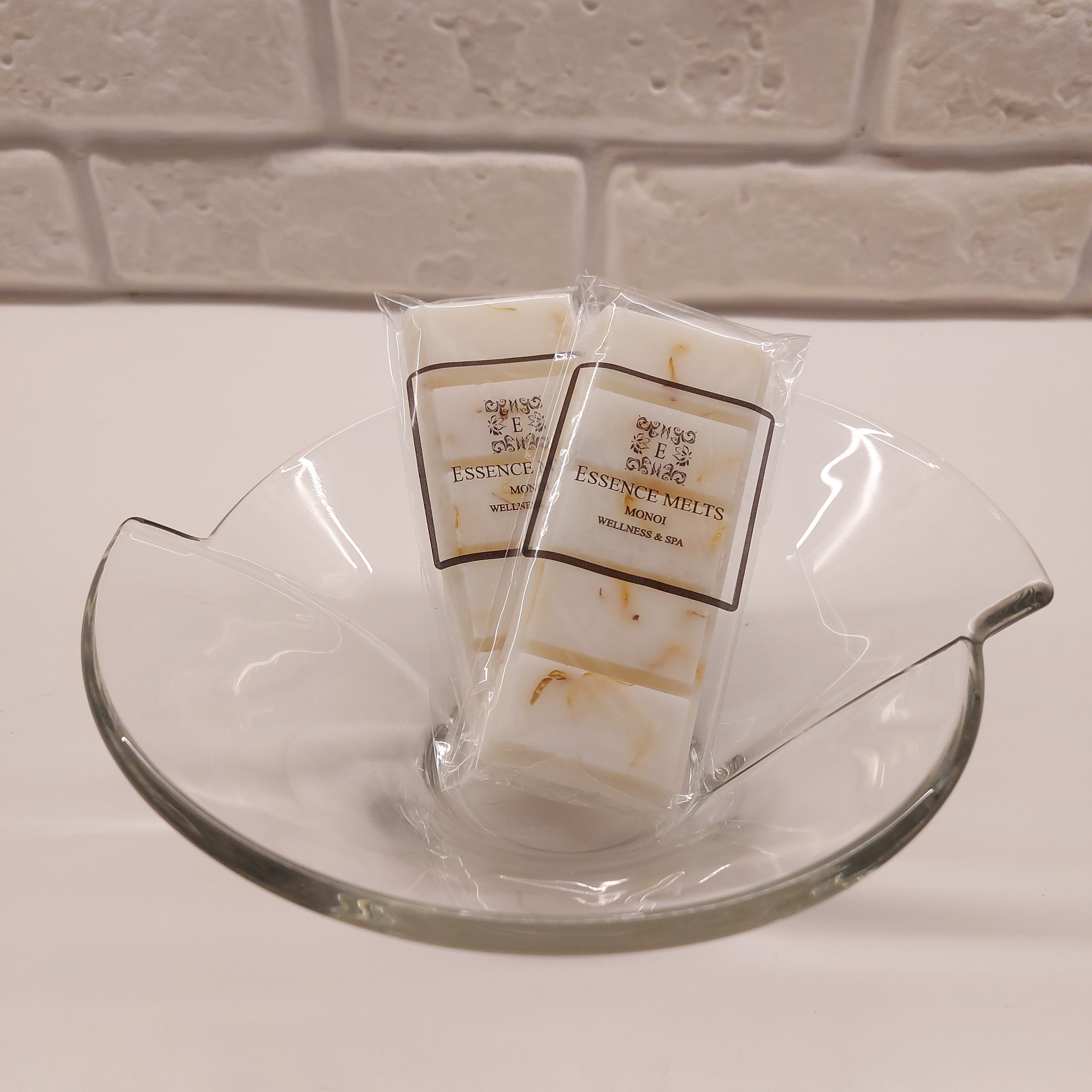 Monoi scented soy wax melt snap bar wrapped in clear cellophane with Essence Melts logo