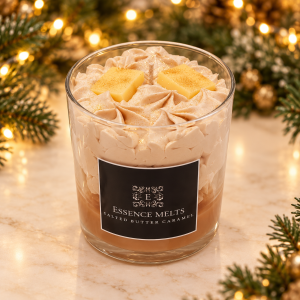 Salted Butter Caramel candle with creamy whipped wax and yellow butter-shaped wax decorations, framed by Christmas greenery and golden lights.