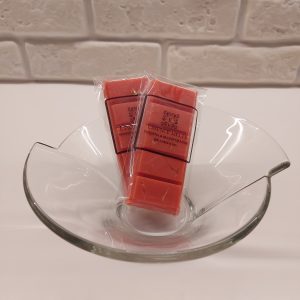 Verbena & Blood Orange Wax Melts in clear biodegradable packaging with Essence Melts logo, styled on a citrus-themed background.