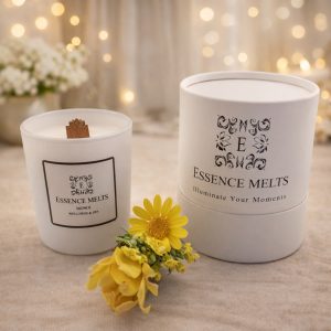 Monoi scented candle in a white ceramic container with a cherry wood wick, surrounded by tropical flowers and coconut. Spa candles