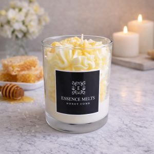 Honeycomb - candle in a glass jar with a whipped white topping, yellow sprinkles, and honeycomb-shaped wax accents, displayed with pearl ornaments. Dessert candles