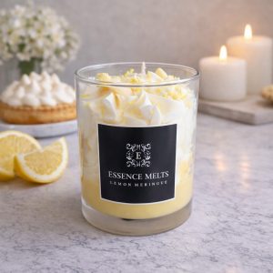Lemon Meringue - candle in a glass jar with whipped white topping, yellow sprinkles, and lemon-shaped wax accents, displayed with pearl ornaments. Dessert candles
