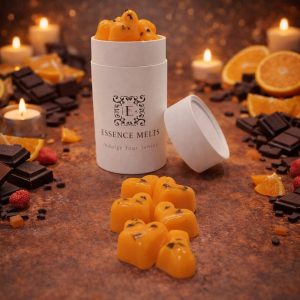 Orange Chocolate scented wax melts in Essence Melts container styled with dark chocolate pieces, fresh orange slices and warm candlelight background.