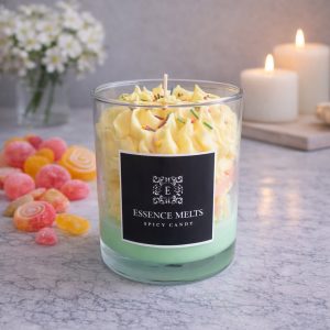 Spicy Candy candle in a glass jar with whipped cream-like topping, colorful sprinkles, and heart-shaped wax accents, displayed with pearl ornaments. Dessert candles