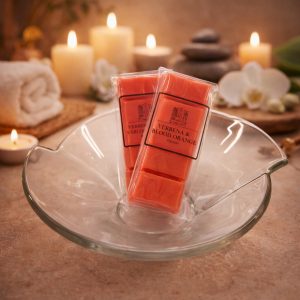 Verbena & Blood Orange wax melts by Essence Melts styled in a luxury spa setting with candles, orchid flowers and soft ambient lighting.