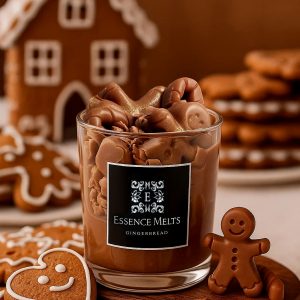 Gingerbread scented candle in glass jar with whipped wax top, holiday pearl decoration, and chocolate gingerbread figurine. Dessert candles