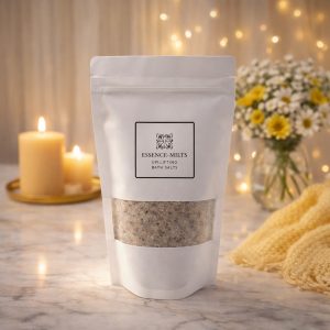 Essence Melts Uplifting Bath Salts in white resealable pouch with mineral crystals displayed on elegant cozy background