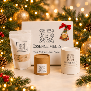 Essence Melts Christmas gift set with a bath salts pouch, bath bomb tube and ivory branded tube beside a white gift box with a red bow.