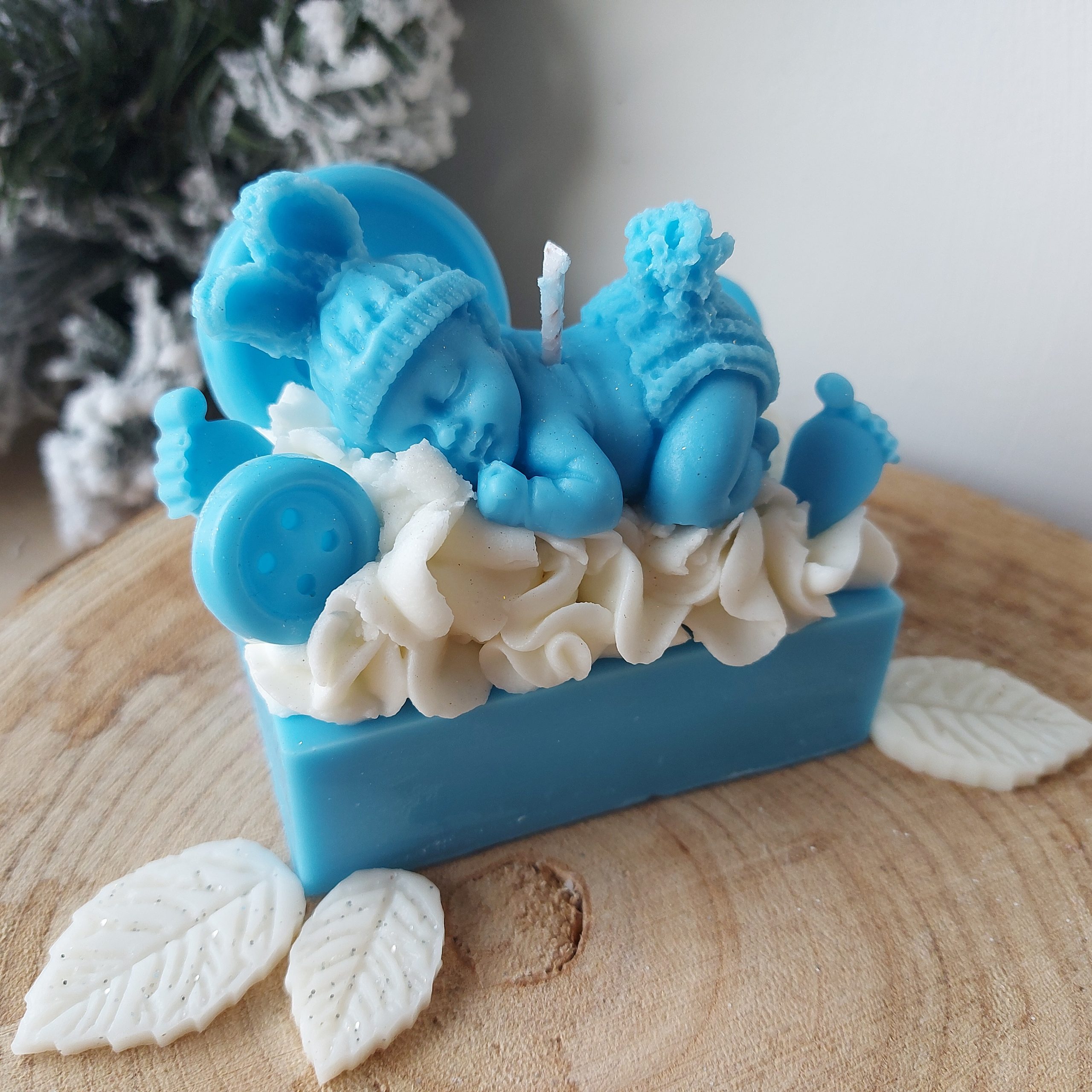 Essence Melts baby boy-themed candle with soft blue wax decorations, white container, and matching gift packaging