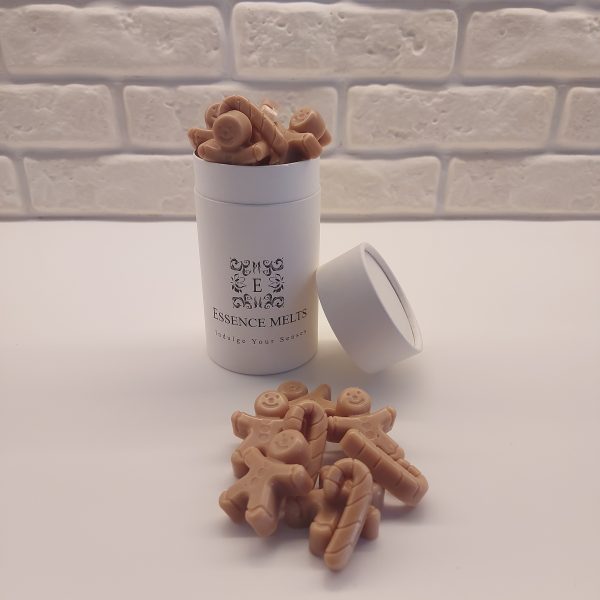 Essence Melts gingerbread candle in a white jar with whipped wax topping and wax gingerbread cookie decorations.