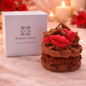 Valentine’s cookie candle with red lips, strawberry and chocolate wax toppings beside an Essence Melts gift box on a cozy romantic background.