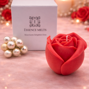 Red rose-shaped soy wax Valentine candle beside a white Essence Melts box and pearl decoration.