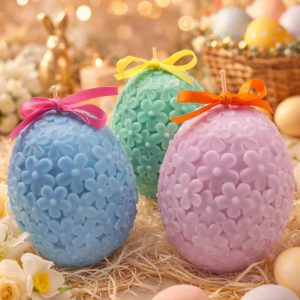 Easter Egg Candle with floral texture in pastel colors and decorative ribbon bows