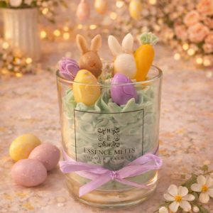 Easter-themed soy wax candle in glass with bunny, carrot, and egg decorations