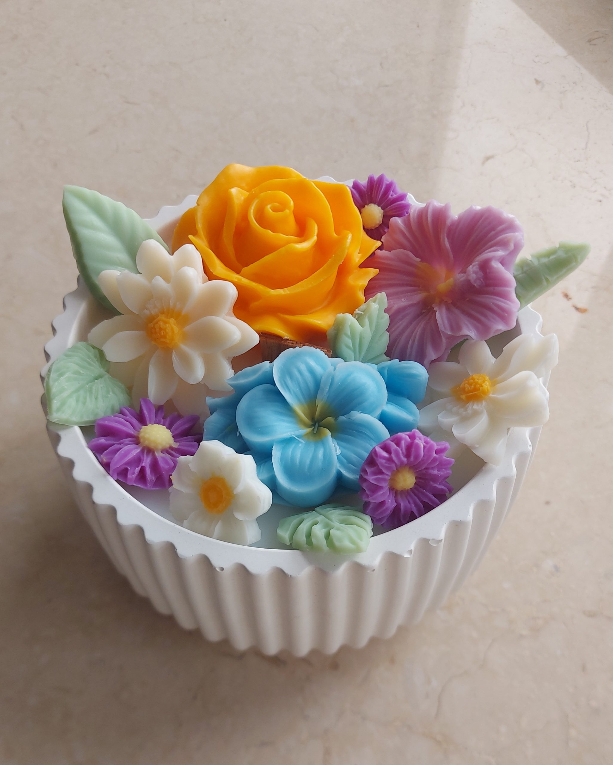 Nectar Bloom wax flower candle in a white ceramic bowl with soft peach, ivory, and blush wax florals, handcrafted and unscented.