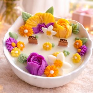 Monoi Bloom monoi scented candle with colorful floral design and wooden wicks for Mother’s Day