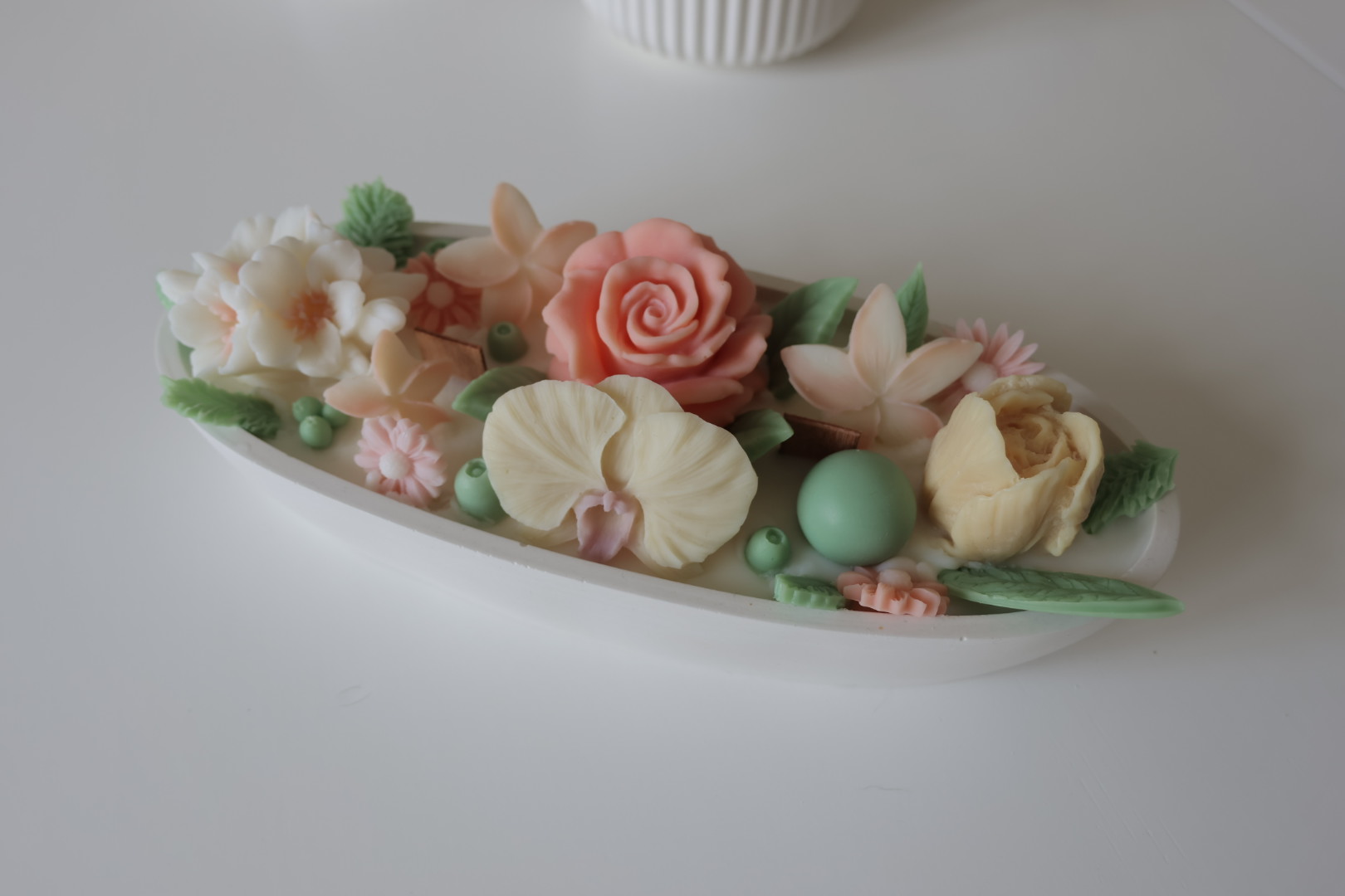 Botanical Bloom N°3 – candle with intricate wax flowers in soft pastel shades, set in a ribbed white heat resistant bowl.