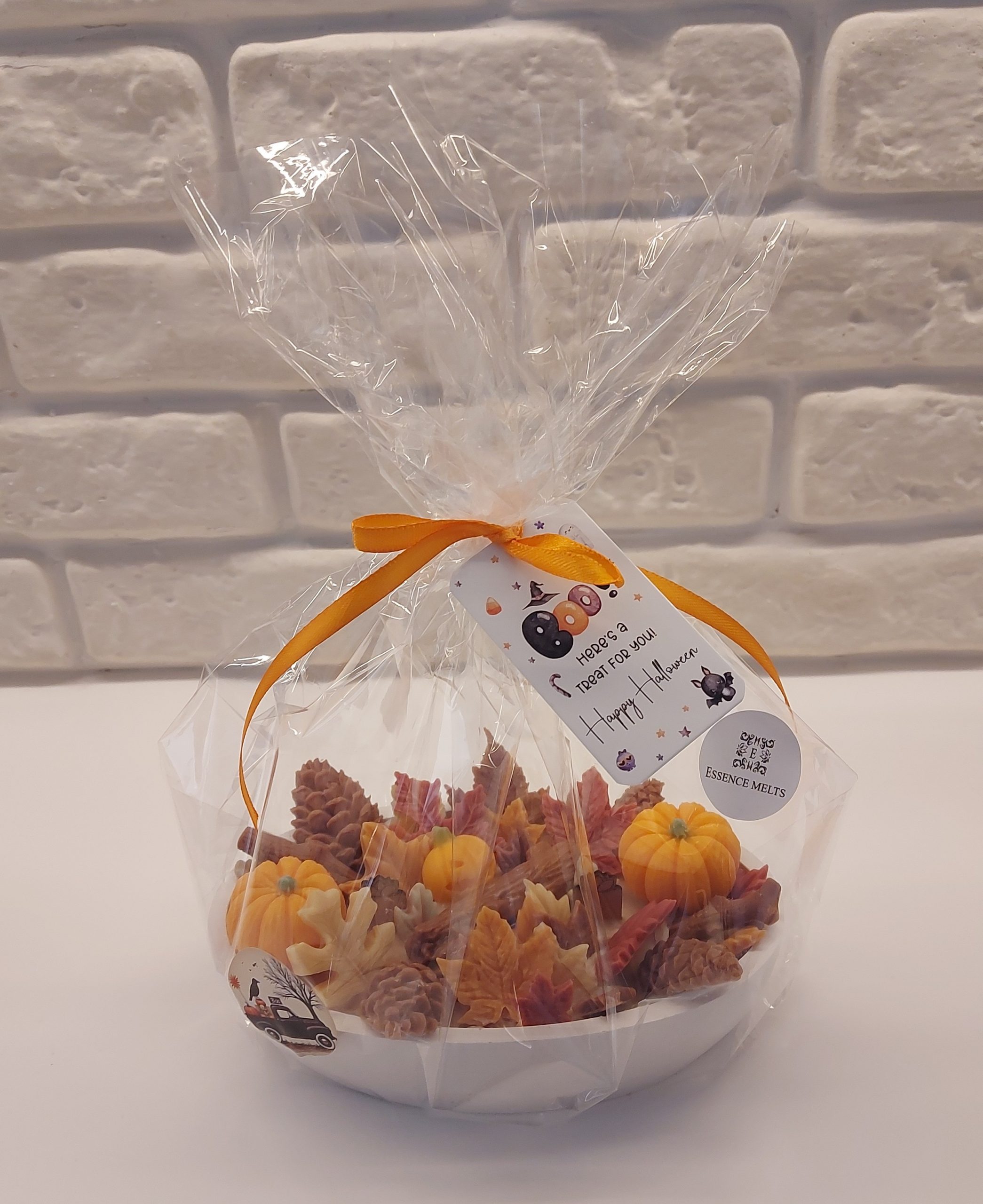 Wicked Leafy Woods N°1 Halloween patchouli candle wrapped in clear cellophane with orange ribbon, Boo tag, and festive sticker.