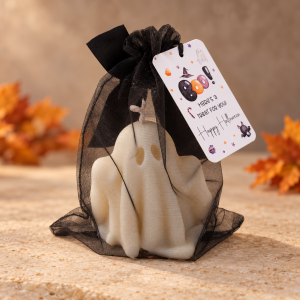 White Big Boo ghost candle in a sheer black organza bag with a black ribbon and Halloween gift tag.
