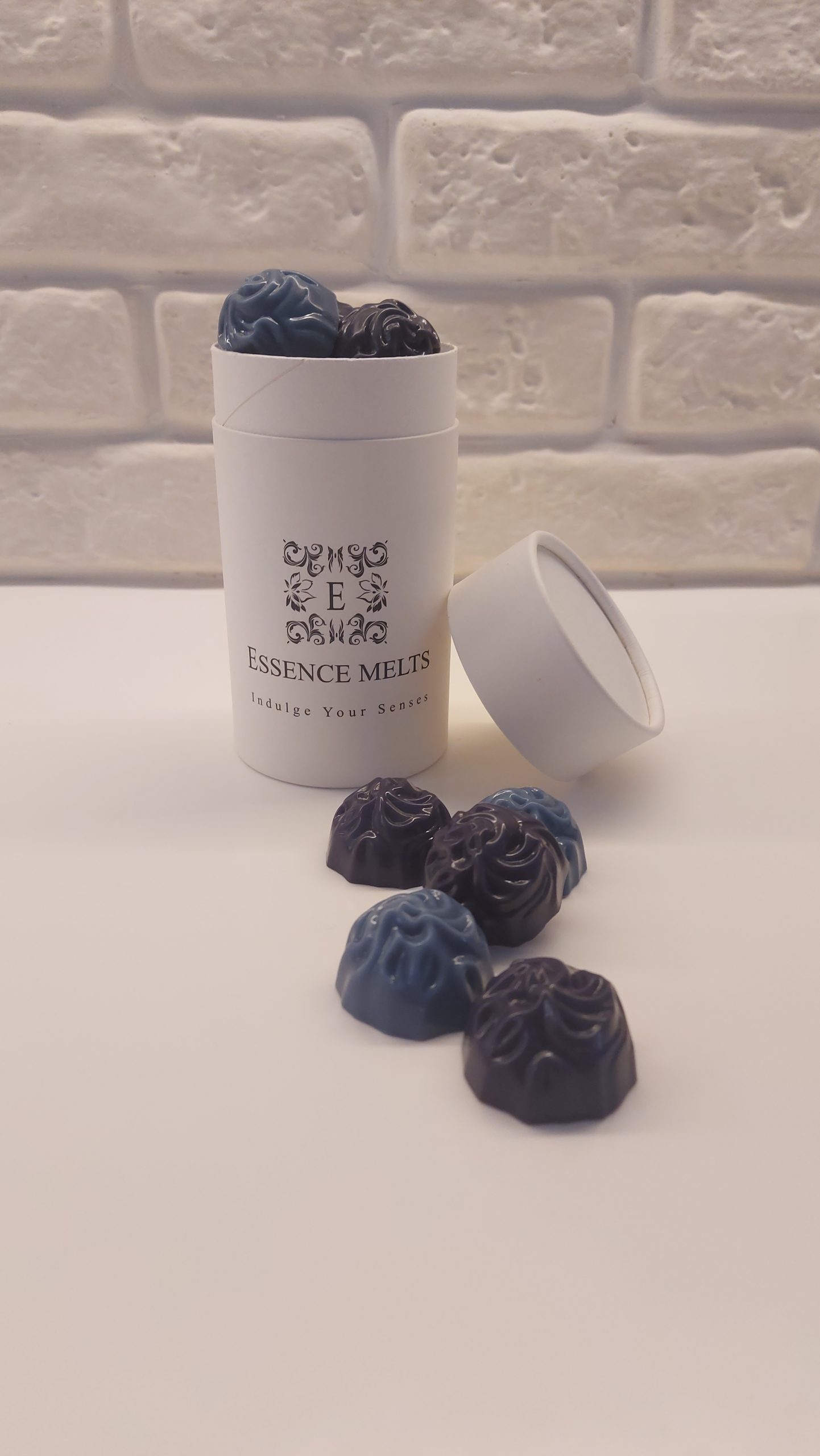 Blackberry and blueberry scented soy wax melts in purple and blue, displayed with Essence Melts branded packaging.