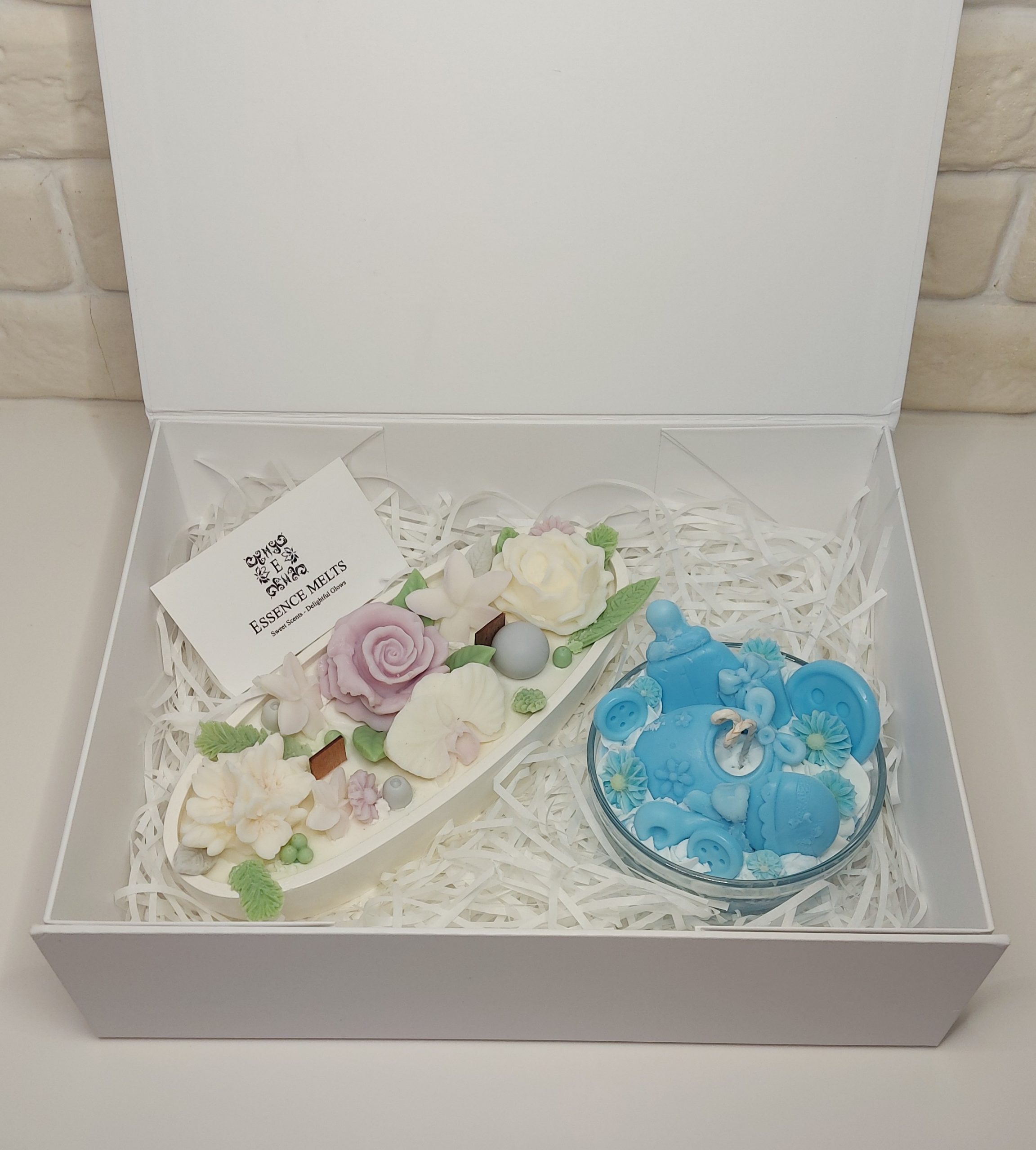 Blue Little Blessing baby boy candle gift box packaging with floral candle and baby-themed candle inside.