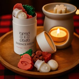 Festive Christmas wax melts in Santa, gingerbread, and holly shapes displayed beside a lit wax warmer on a wooden tray.
