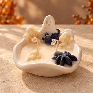 Ghost Vanilla candle in a handmade ivory ghost-shaped vessel with wax ghosts, a black cat, a spider and two cotton wicks.